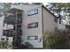Two-story condo with two balconies, wood siding, and several windows surrounded by trees at 543 Pine Ridge Place, Raleigh, NC 27609