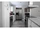 Well-lit kitchen with stainless steel appliances, granite countertops, and white cabinets at 543 Pine Ridge Place, Raleigh, NC 27609