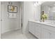 Bright bathroom featuring double sink vanity, modern lighting, and marble-look tile at 600 Hedrick Ridge Road # 104, Cary, NC 27519