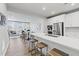 Modern kitchen featuring white cabinets, stainless steel appliances, and a spacious island with seating at 600 Hedrick Ridge Road # 104, Cary, NC 27519