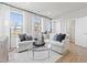 Bright living area with a sectional sofa, decorative pillows, and large windows with sheer curtains at 600 Hedrick Ridge Road # 104, Cary, NC 27519