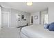 Serene bedroom view showcasing a plush bed, dresser, and a glimpse into the ensuite bathroom for a relaxing retreat at 600 Hedrick Ridge Road # 108, Cary, NC 27519