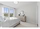Bright bedroom with large windows, dresser with round mirror and modern lamp at 600 Hedrick Ridge Road # 108, Cary, NC 27519
