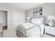 Neutral bedroom with a queen size bed, soft textures and double door closet at 600 Hedrick Ridge Road # 108, Cary, NC 27519