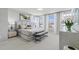 Luxurious bedroom featuring a plush bed, stylish bench, and ample natural light from large windows with sheer curtains at 600 Hedrick Ridge Road # 108, Cary, NC 27519