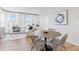 Charming dining area with a round table, comfortable seating, and bright natural light from large windows at 600 Hedrick Ridge Road # 108, Cary, NC 27519