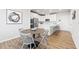 Open-concept kitchen with white cabinets, stainless steel appliances, and a breakfast bar adjacent to the dining area at 600 Hedrick Ridge Road # 108, Cary, NC 27519