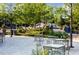 Relaxing outdoor seating area with tables, chairs, and lush greenery, ideal for enjoying meals or conversation at 600 Hedrick Ridge Road # 108, Cary, NC 27519