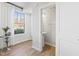 Well-lit powder room with a pedestal sink, contemporary fixtures, and natural light streaming through a window at 600 Hedrick Ridge Road # 108, Cary, NC 27519