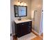 Modern bathroom with a dark vanity, granite countertop, and a sleek mirror, creating a stylish and functional space at 601 Aiken Pkwy, Fuquay Varina, NC 27526
