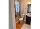 Bathroom featuring a modern toilet, vanity, mirror, and patterned curtain, creating a charming, updated space at 601 Aiken Pkwy, Fuquay Varina, NC 27526