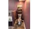 Compact bathroom featuring a toilet, decorative shelves, and painted in a unique dark purple at 601 Aiken Pkwy, Fuquay Varina, NC 27526