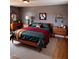 Stylish bedroom featuring a wood bed, modern decor, and warm lighting, creating a cozy and inviting atmosphere at 601 Aiken Pkwy, Fuquay Varina, NC 27526