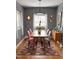 Charming dining room with colorful chairs, a modern light fixture, and gray walls at 601 Aiken Pkwy, Fuquay Varina, NC 27526