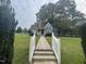 Charming blue home with a stone chimney and well-manicured lawn at 601 Aiken Pkwy, Fuquay Varina, NC 27526