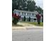 Two-story blue home with dark shutters and vibrant red crape myrtle trees at 601 Aiken Pkwy, Fuquay Varina, NC 27526