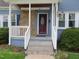Inviting front porch with stone accents and a classic red door at 601 Aiken Pkwy, Fuquay Varina, NC 27526