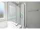 Bathroom features a glass enclosed shower with white tile and a window providing natural light at 604 Chadbourne Dr, Durham, NC 27703