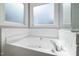 A soaking bathtub with a corner window adds a spa-like feel to the bathroom at 604 Chadbourne Dr, Durham, NC 27703