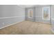 Bedroom with neutral carpet and paint, featuring two large windows for ample natural light at 604 Chadbourne Dr, Durham, NC 27703
