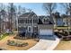 Inviting two-story home with an attached garage, landscaped yard, and a welcoming front entrance with stairs at 604 Chadbourne Dr, Durham, NC 27703