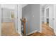 Hallway featuring hardwood floors and staircase at 604 Chadbourne Dr, Durham, NC 27703