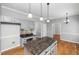 Bright kitchen features a center island, stylish backsplash and gray cabinets at 604 Chadbourne Dr, Durham, NC 27703