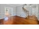 Spacious living room with hardwood floors, white trim, neutral walls, and glass-paneled doors to the dining room at 604 Chadbourne Dr, Durham, NC 27703