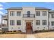 Stunning three-story building with a light brick exterior, black trim, and a welcoming entrance at 605 Smedes Pl # B, Raleigh, NC 27605