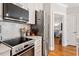 Modern kitchen with stainless steel appliances, white cabinetry, and a stylish tile backsplash at 605 Smedes Pl # B, Raleigh, NC 27605