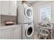 Convenient laundry area equipped with a stackable washer and dryer, and vanity at 605 Smedes Pl # B, Raleigh, NC 27605