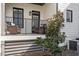 Covered porch with comfortable wicker seating and black metal railings, perfect for relaxing outdoors at 605 Smedes Pl # B, Raleigh, NC 27605
