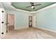 Bedroom featuring a neutral color palette, plush carpeting, ceiling fan, walk-in closet, and en-suite bathroom at 70 Breadnut Dr, Smithfield, NC 27577