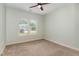 Bedroom with neutral carpet, a ceiling fan, and a window offering views of the surrounding neighborhood at 70 Breadnut Dr, Smithfield, NC 27577