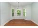 Bright breakfast nook featuring hardwood floors and three large windows offering ample natural light and serene views at 70 Breadnut Dr, Smithfield, NC 27577