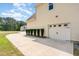 Side exterior shows long driveway, landscaping, and white garage door at 70 Breadnut Dr, Smithfield, NC 27577