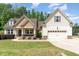 Charming home featuring manicured lawn and a two-car garage, blending comfort and curb appeal at 70 Breadnut Dr, Smithfield, NC 27577