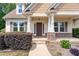 Inviting front porch with stone accents, offering a warm welcome to this charming home at 70 Breadnut Dr, Smithfield, NC 27577