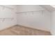 Walk-in closet with neutral carpet, white walls, and multiple tiers of wire shelving for optimal storage at 70 Breadnut Dr, Smithfield, NC 27577