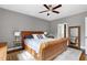 Bedroom with gray walls, ceiling fan, and a wicker bed with white bedding and an decorative rug at 773 Rebecca Ln, Siler City, NC 27344