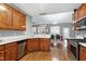 Open-concept kitchen flows into the dining room, with hardwood floors and wood cabinets at 773 Rebecca Ln, Siler City, NC 27344