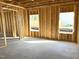 Unfinished basement featuring wooden framing and natural light coming through two windows at 86 Olivia Crossing Ct # 3, Four Oaks, NC 27524