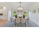 An elegant dining room with a decorative light fixture and a large window with a view of the outdoors at 86 Olivia Crossing Ct # 3, Four Oaks, NC 27524