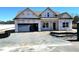 New construction home featuring an attached garage, gabled roof and classic window styles at 86 Olivia Crossing Ct # 3, Four Oaks, NC 27524