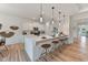 Bright, modern kitchen featuring a large island with barstool seating, pendant lighting, and stainless steel appliances at 86 Olivia Crossing Ct # 3, Four Oaks, NC 27524