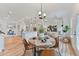 Open floor plan with a dining area, kitchen, and living room, featuring modern lighting and stylish decor at 86 Olivia Crossing Ct # 3, Four Oaks, NC 27524