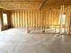 Spacious unfinished room with exposed framing, windows, and a concrete floor awaiting customization at 86 Olivia Crossing Ct # 3, Four Oaks, NC 27524