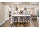 Modern open-concept kitchen with white cabinets, quartz countertops, and stainless steel appliances at 921 Thimbleweed Way, Wake Forest, NC 27587