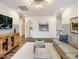 This bright living room is styled with hardwood floors, gray walls, modern furniture, and unique decor at 921 Thimbleweed Way, Wake Forest, NC 27587