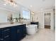 Elegant bathroom showcasing dual vanities, a modern soaking tub, and stylish fixtures at 95 Great Smoky Pl, Lillington, NC 27546